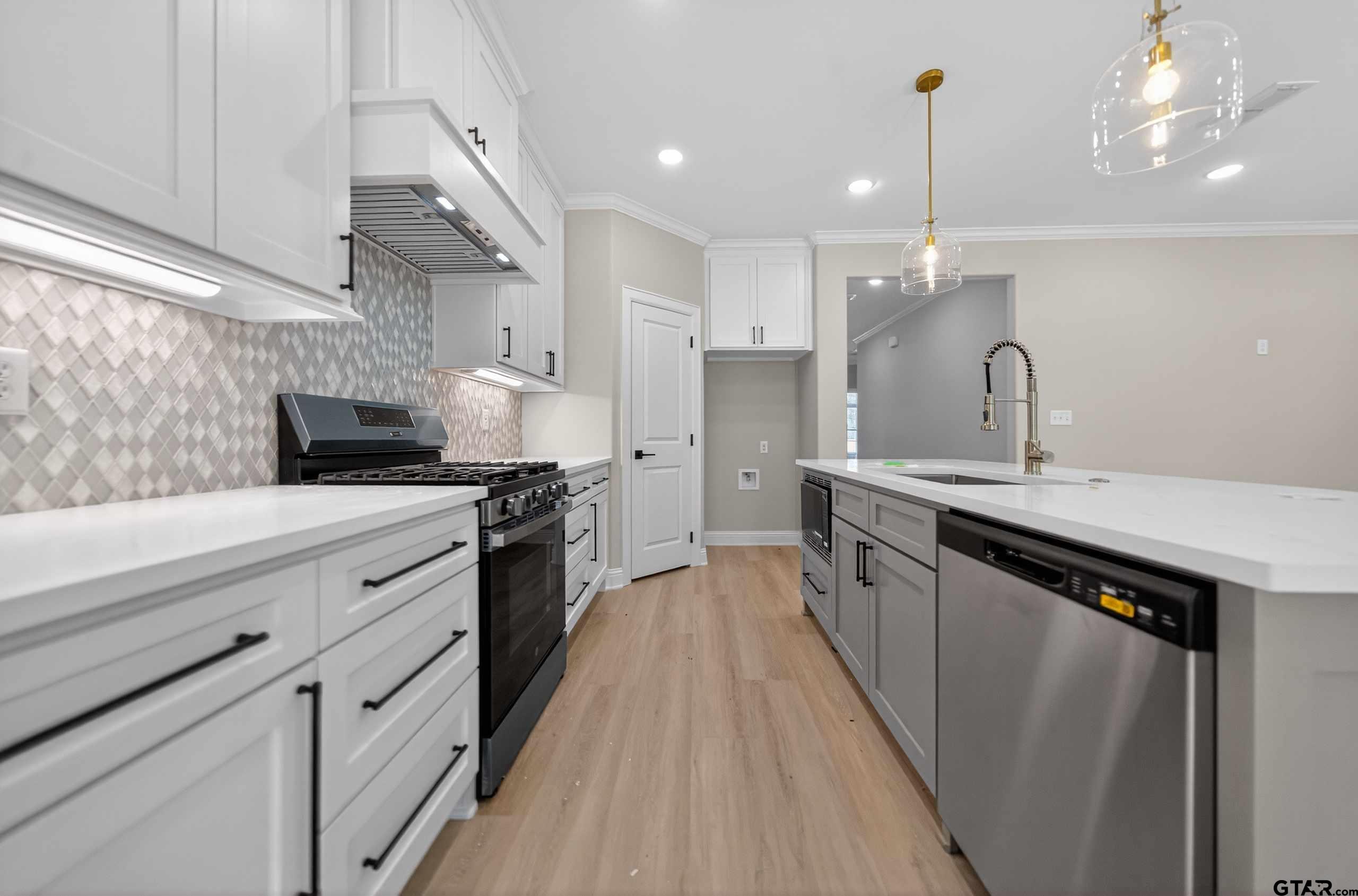 3049 Guinn Farms Road Tyler, TX 75707 - Photo 17 of 43 a open kitchen with stainless steel appliances granite countertop a sink a counter space and cabinets