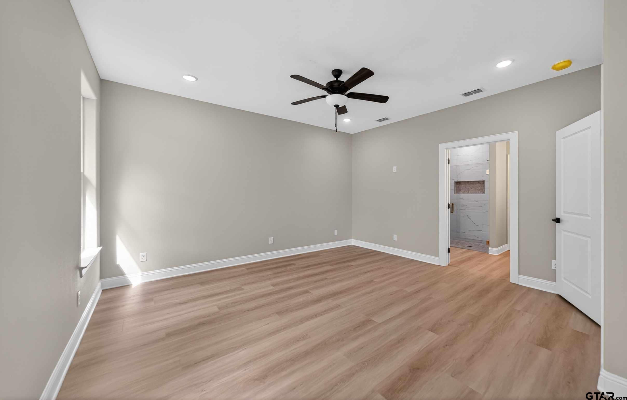 3049 Guinn Farms Road Tyler, TX 75707 - Photo 20 of 43 wooden floor in an empty room with a window