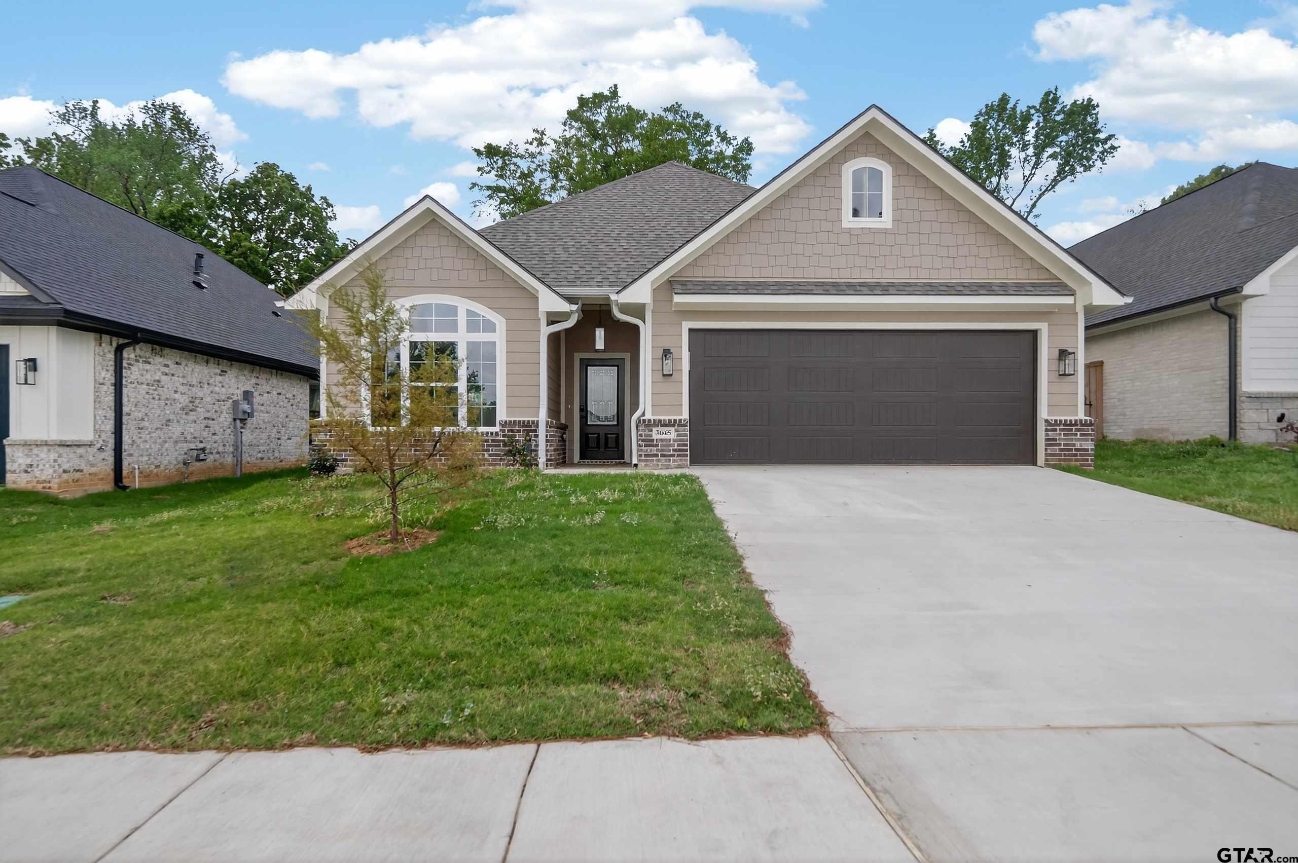 3049 Guinn Farms Road Tyler, TX 75707 - Photo 2 of 43 a front view of a house with a garden and yard
