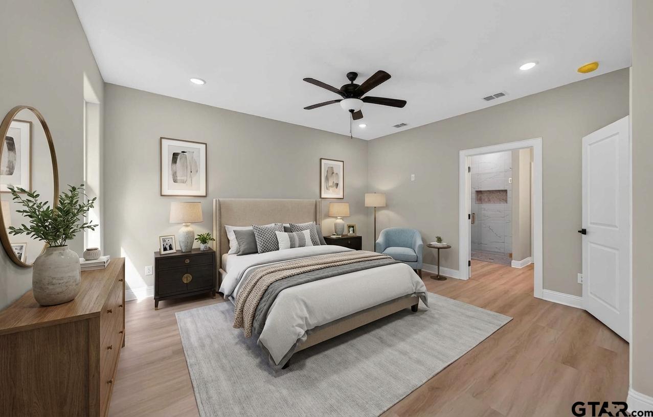 3049 Guinn Farms Road Tyler, TX 75707 - Photo 21 of 43 a bedroom with a large bed and potted plant