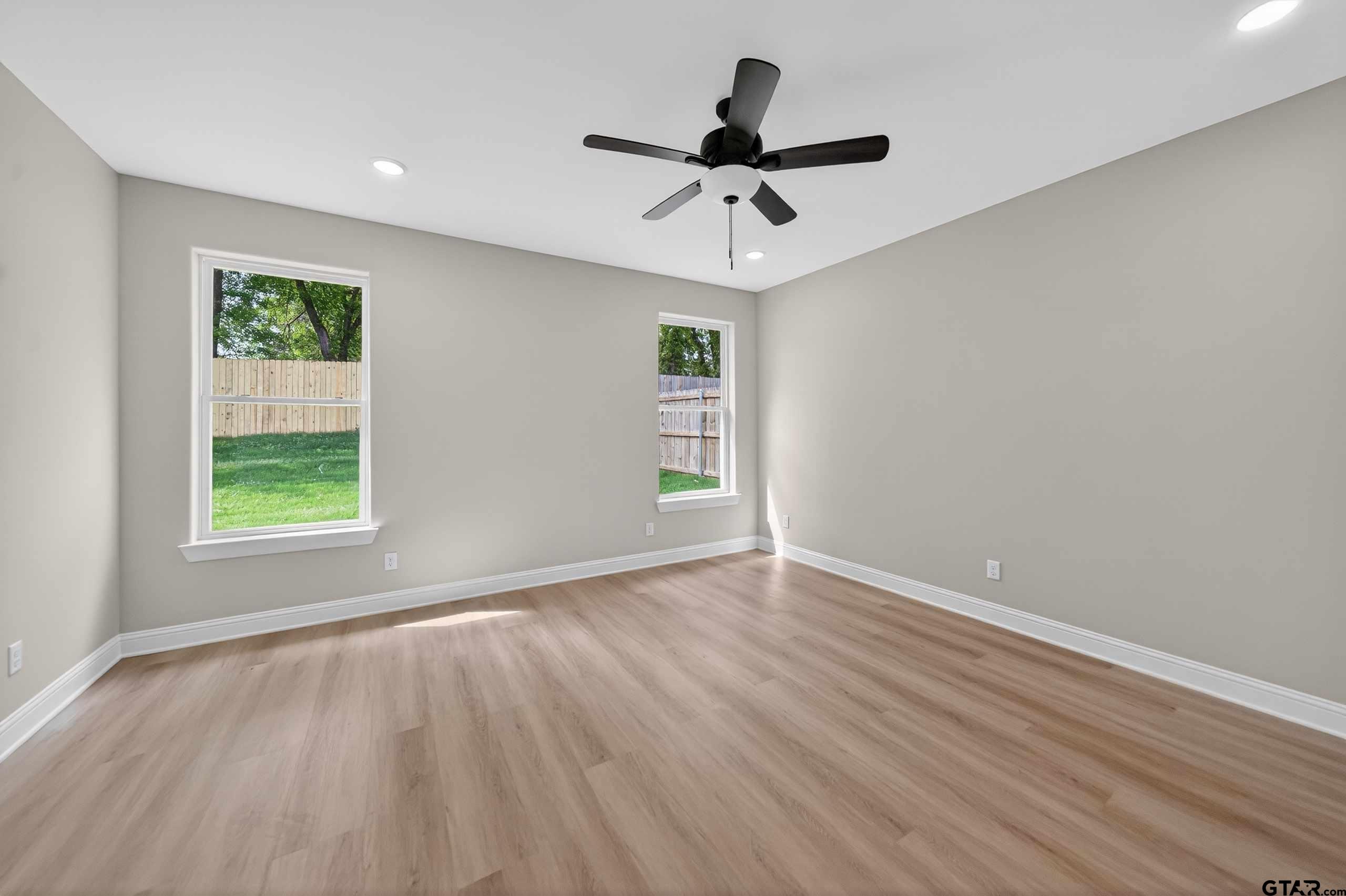 3049 Guinn Farms Road Tyler, TX 75707 - Photo 22 of 43 a view of an empty room with wooden floor and a window