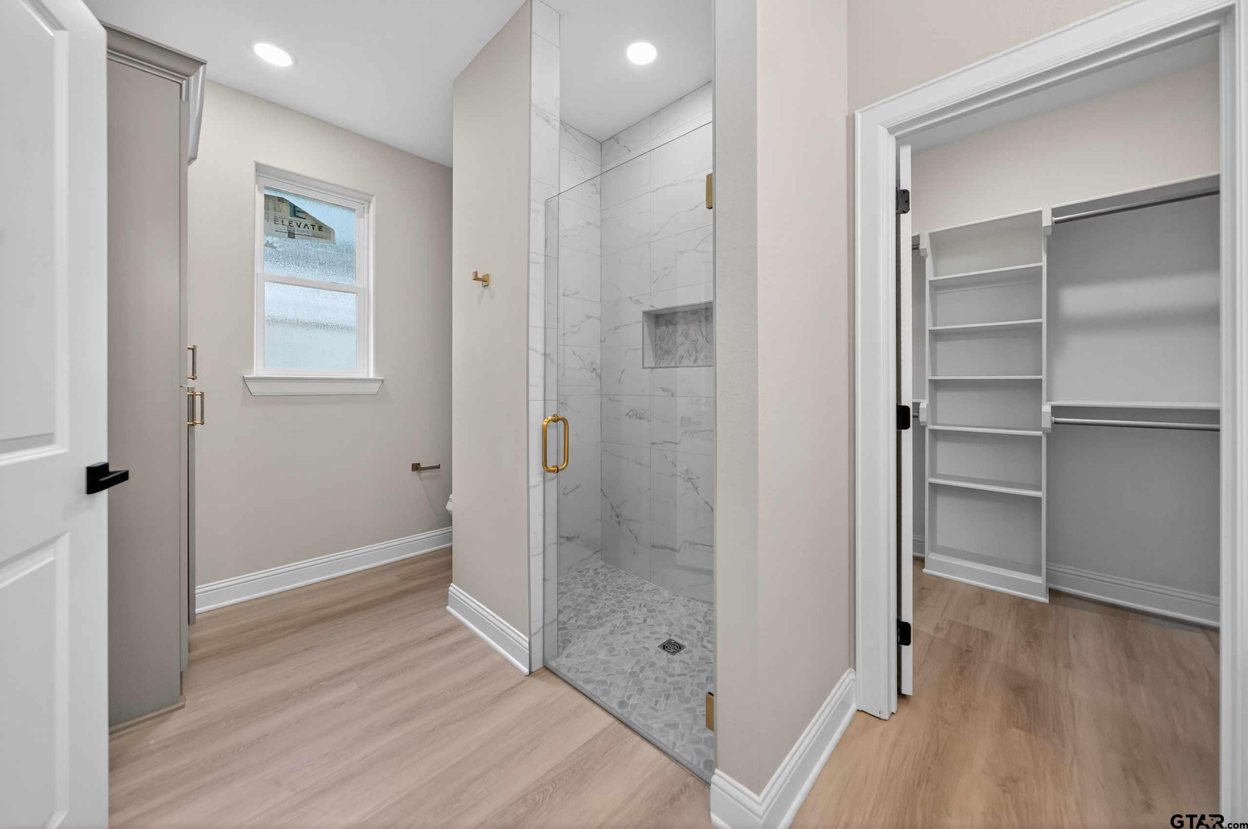 3049 Guinn Farms Road Tyler, TX 75707 - Photo 24 of 43 a bathroom with a shower and a glass door