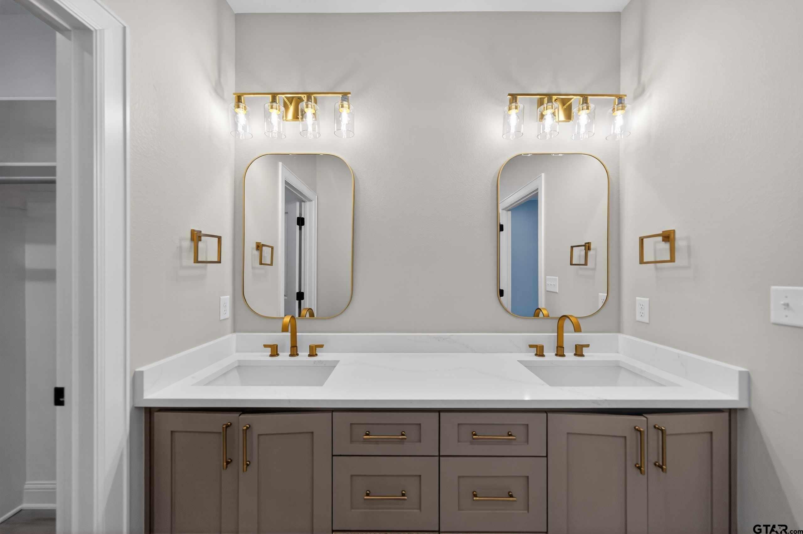 3049 Guinn Farms Road Tyler, TX 75707 - Photo 26 of 43 a bathroom with double vanity sinks and a mirror