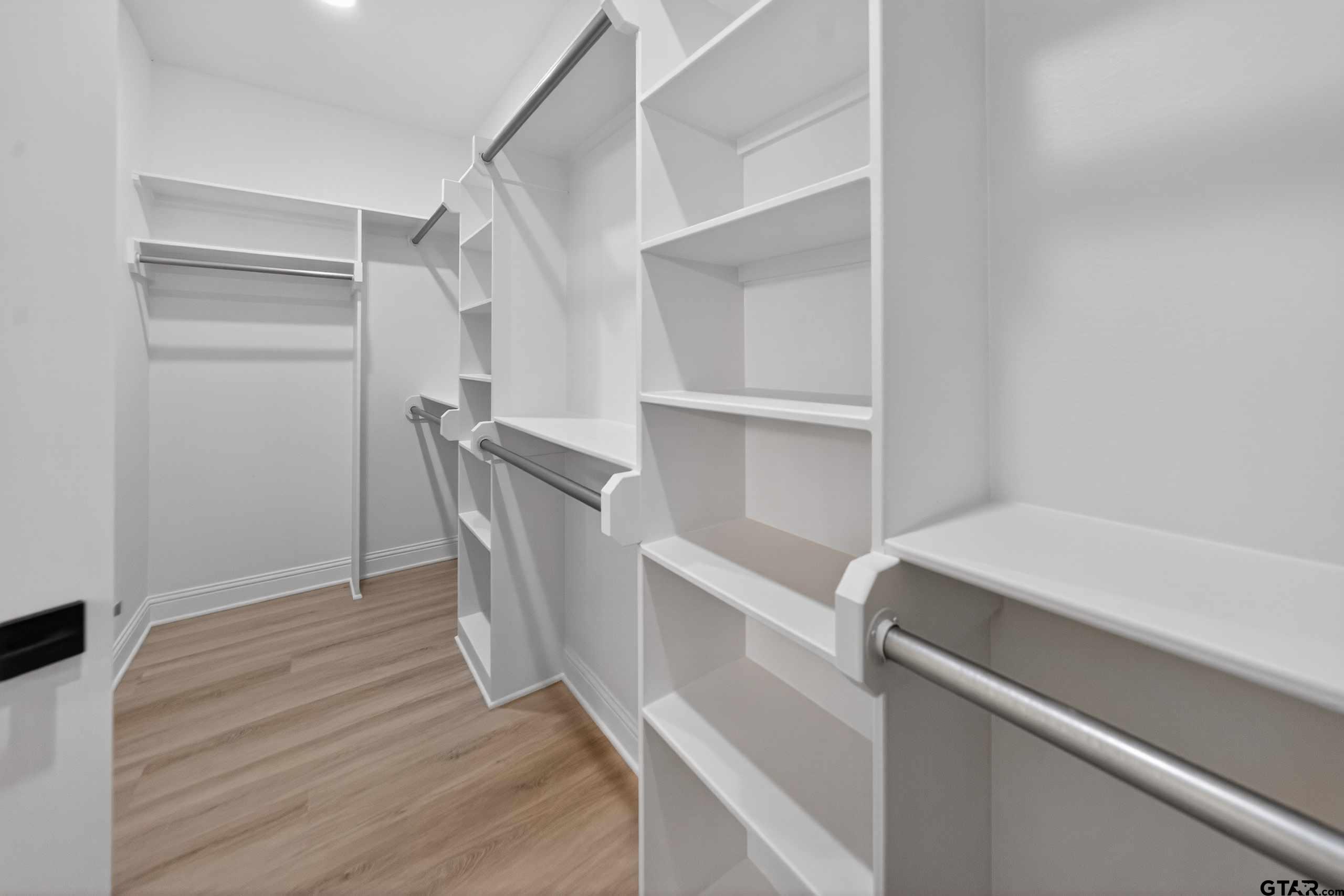 3049 Guinn Farms Road Tyler, TX 75707 - Photo 27 of 43 a room with a closet and wooden floor