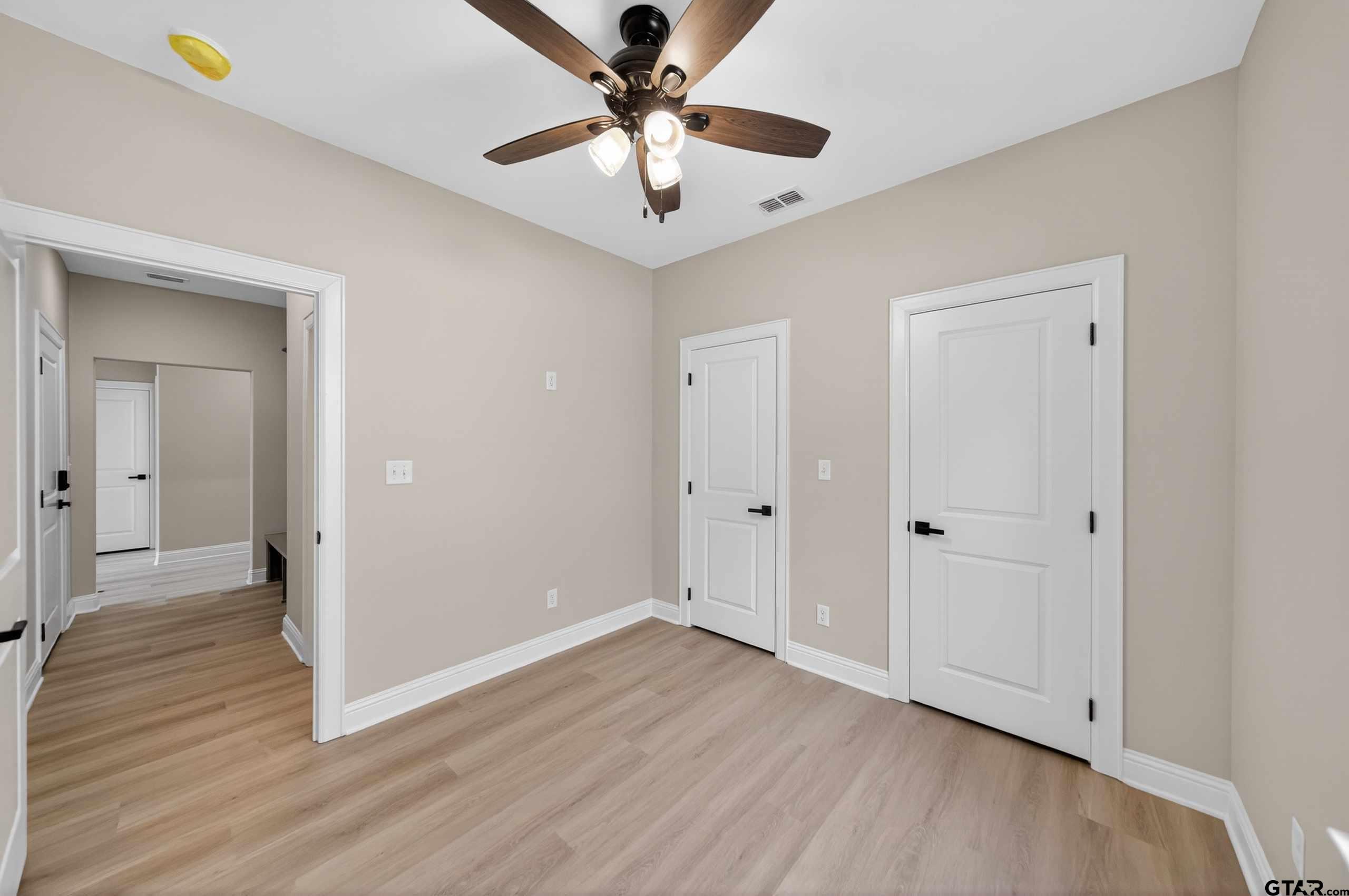 3049 Guinn Farms Road Tyler, TX 75707 - Photo 28 of 43 a view of an empty room with wooden floor