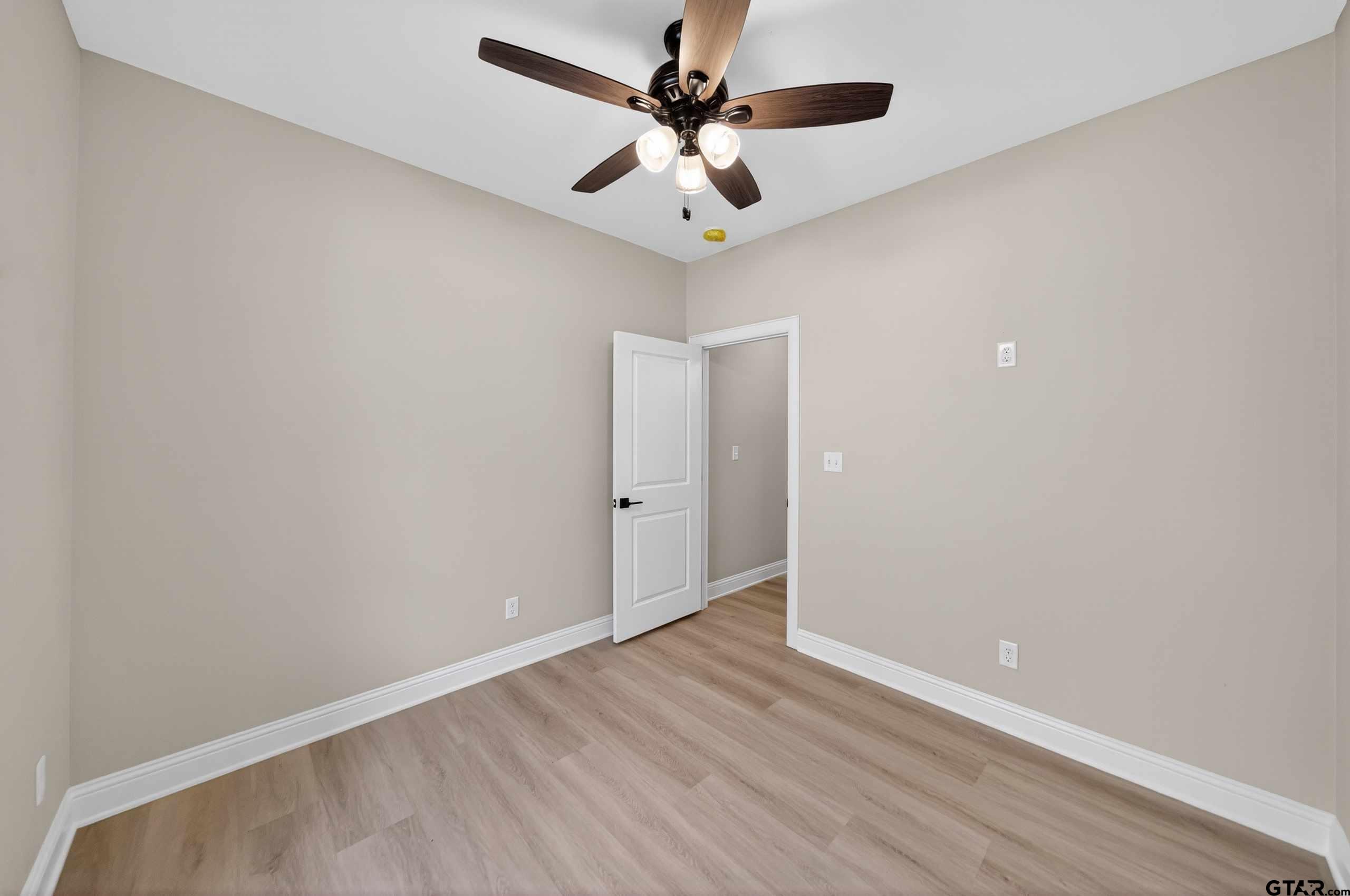 3049 Guinn Farms Road Tyler, TX 75707 - Photo 29 of 43 wooden floor in an empty room