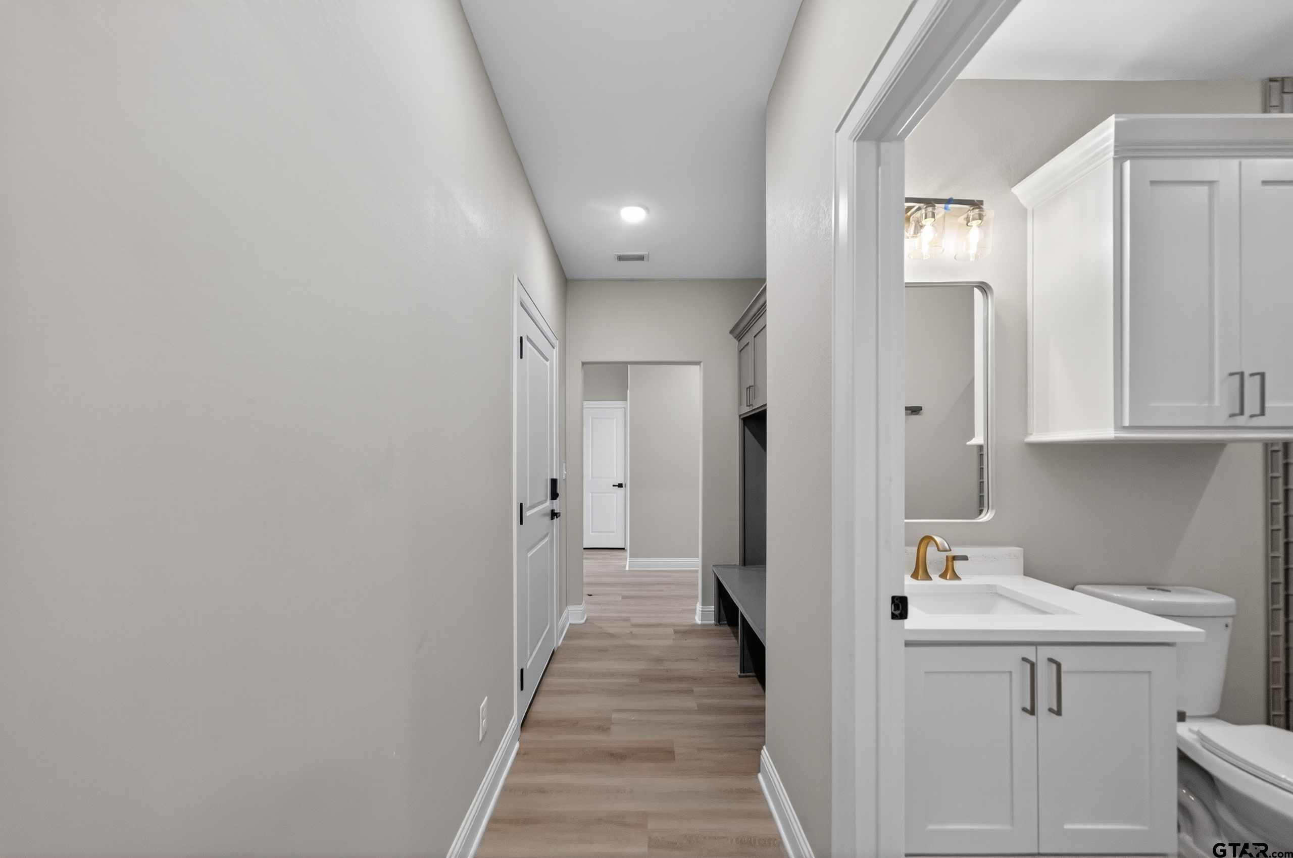 3049 Guinn Farms Road Tyler, TX 75707 - Photo 30 of 43 a view of a hallway with wooden floor and cabinets