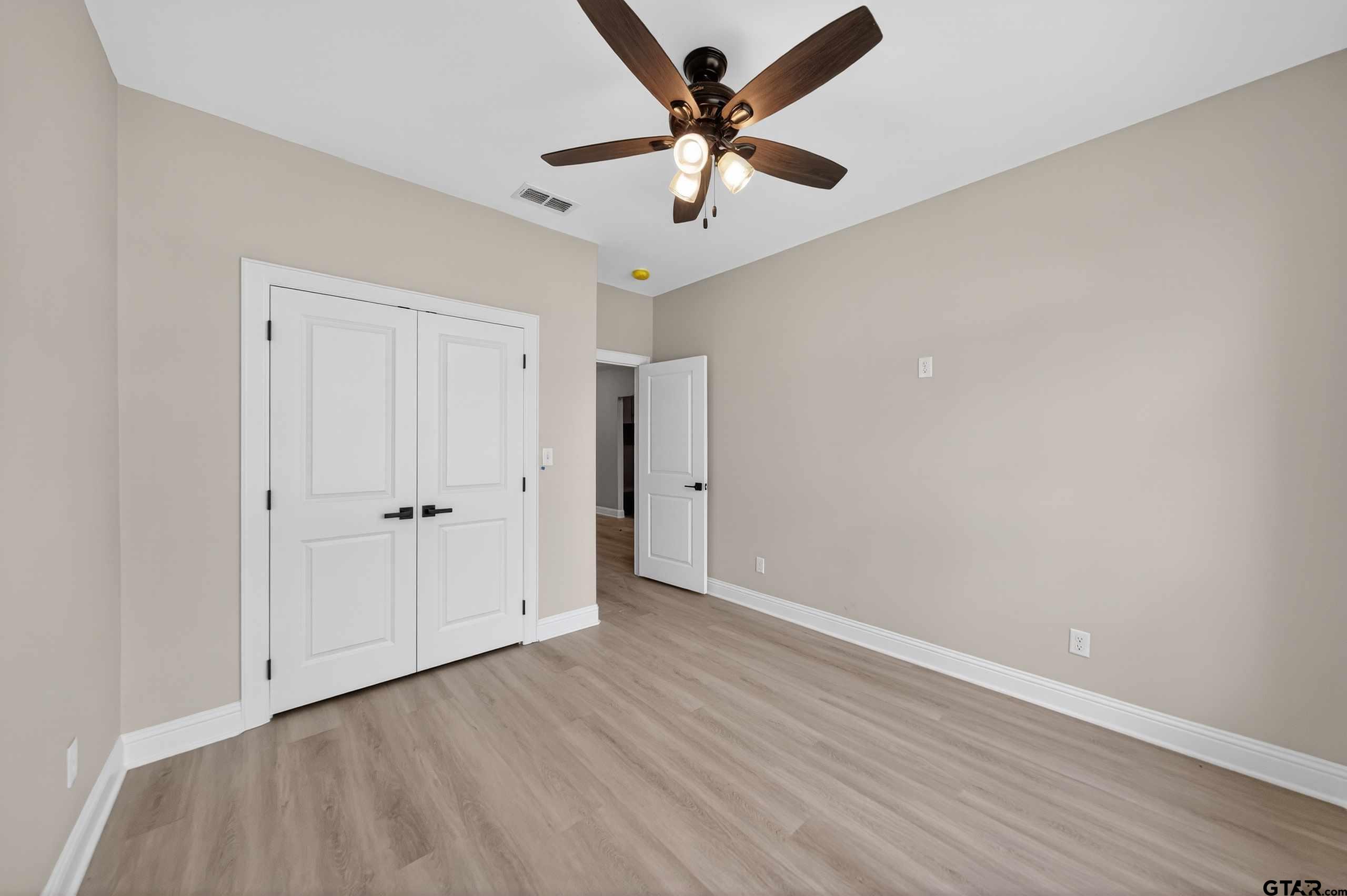 3049 Guinn Farms Road Tyler, TX 75707 - Photo 34 of 43 wooden floor in an empty room