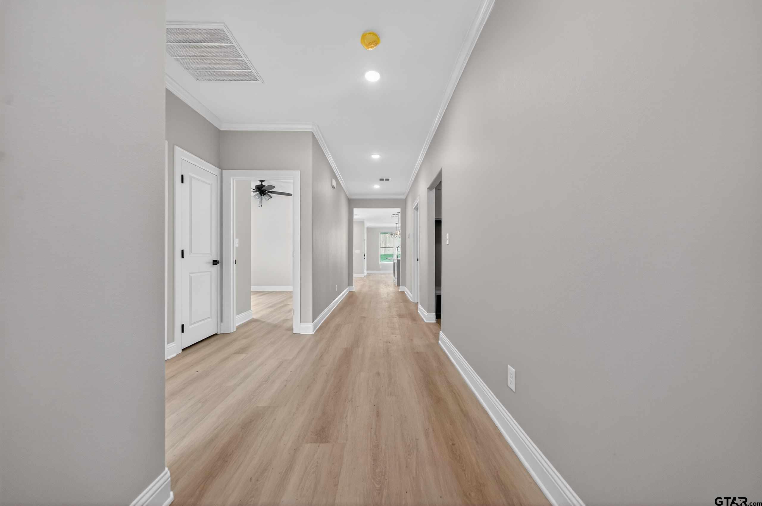 3049 Guinn Farms Road Tyler, TX 75707 - Photo 38 of 43 a view of a hallway with wooden floor