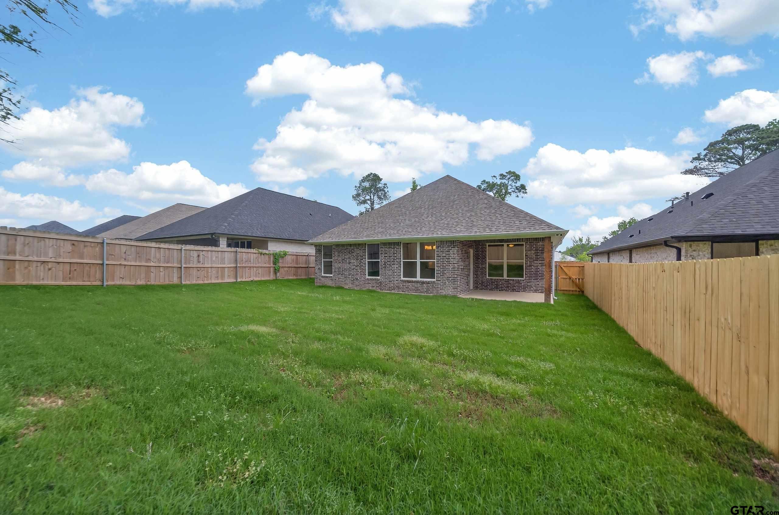 3049 Guinn Farms Road Tyler, TX 75707 - Photo 42 of 43 a view of a yard in front of a house with a large tree