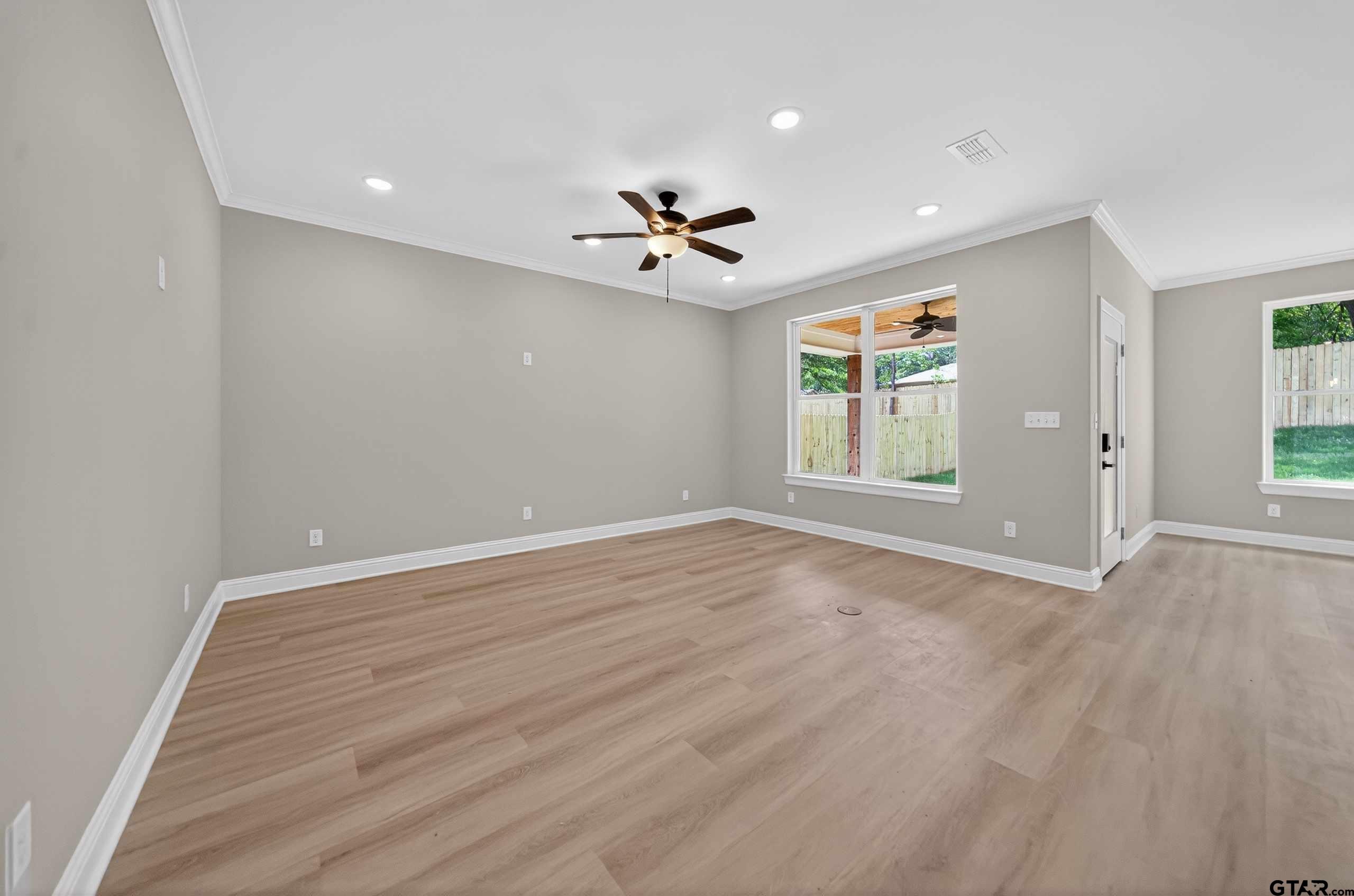 3049 Guinn Farms Road Tyler, TX 75707 - Photo 5 of 43 wooden floor in an empty room with a window