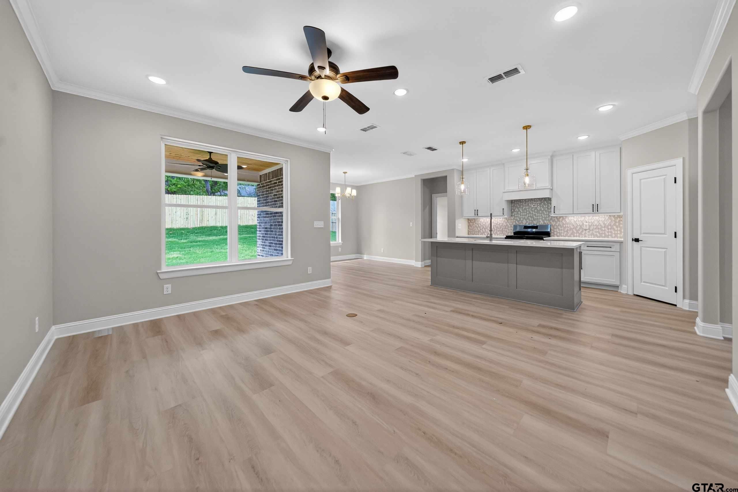 3049 Guinn Farms Road Tyler, TX 75707 - Photo 7 of 43 a view of a kitchen with a stove cabinets and wooden floor