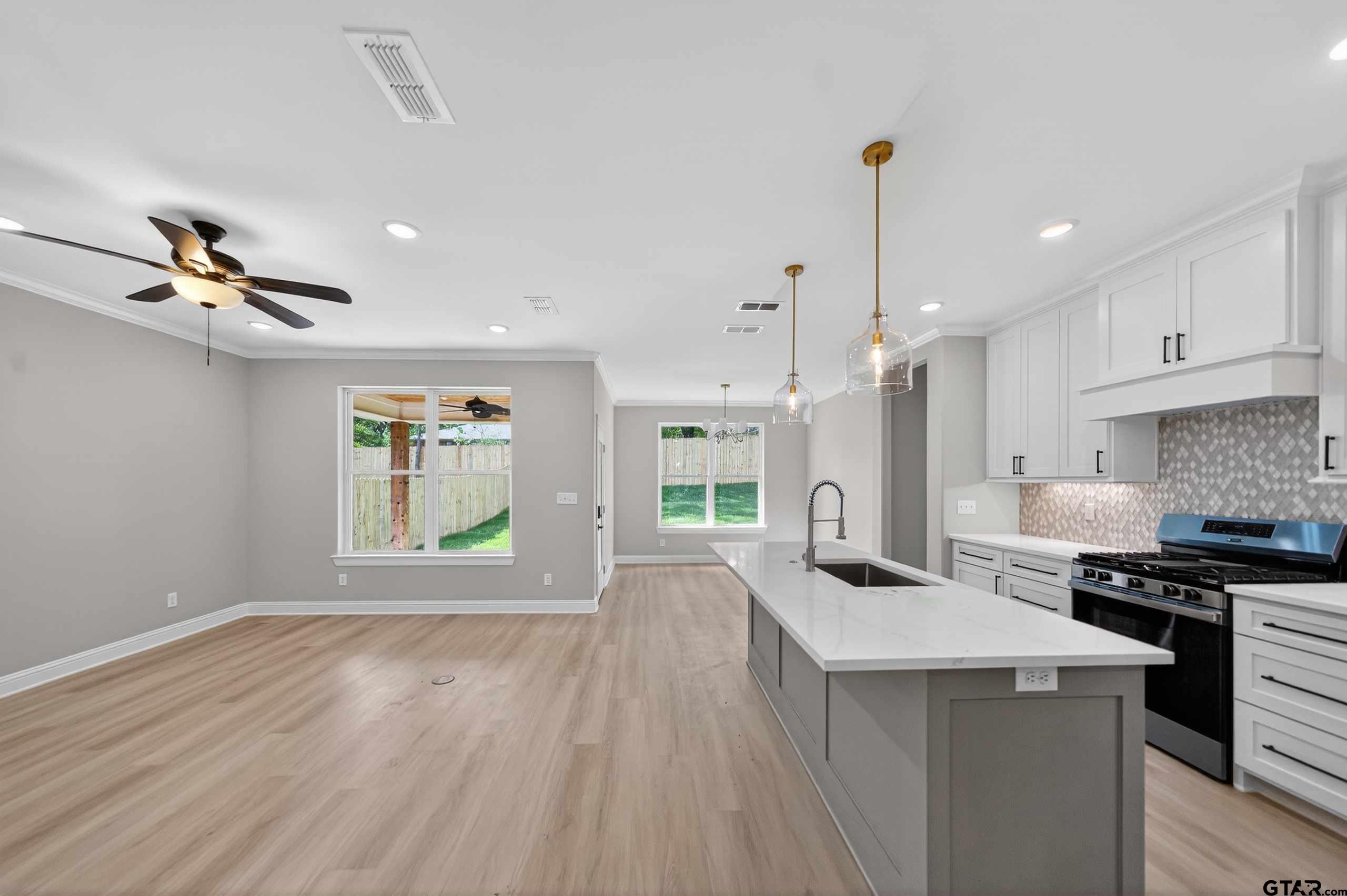3049 Guinn Farms Road Tyler, TX 75707 - Photo 9 of 43 a open kitchen with sink cabinets and stainless steel appliances