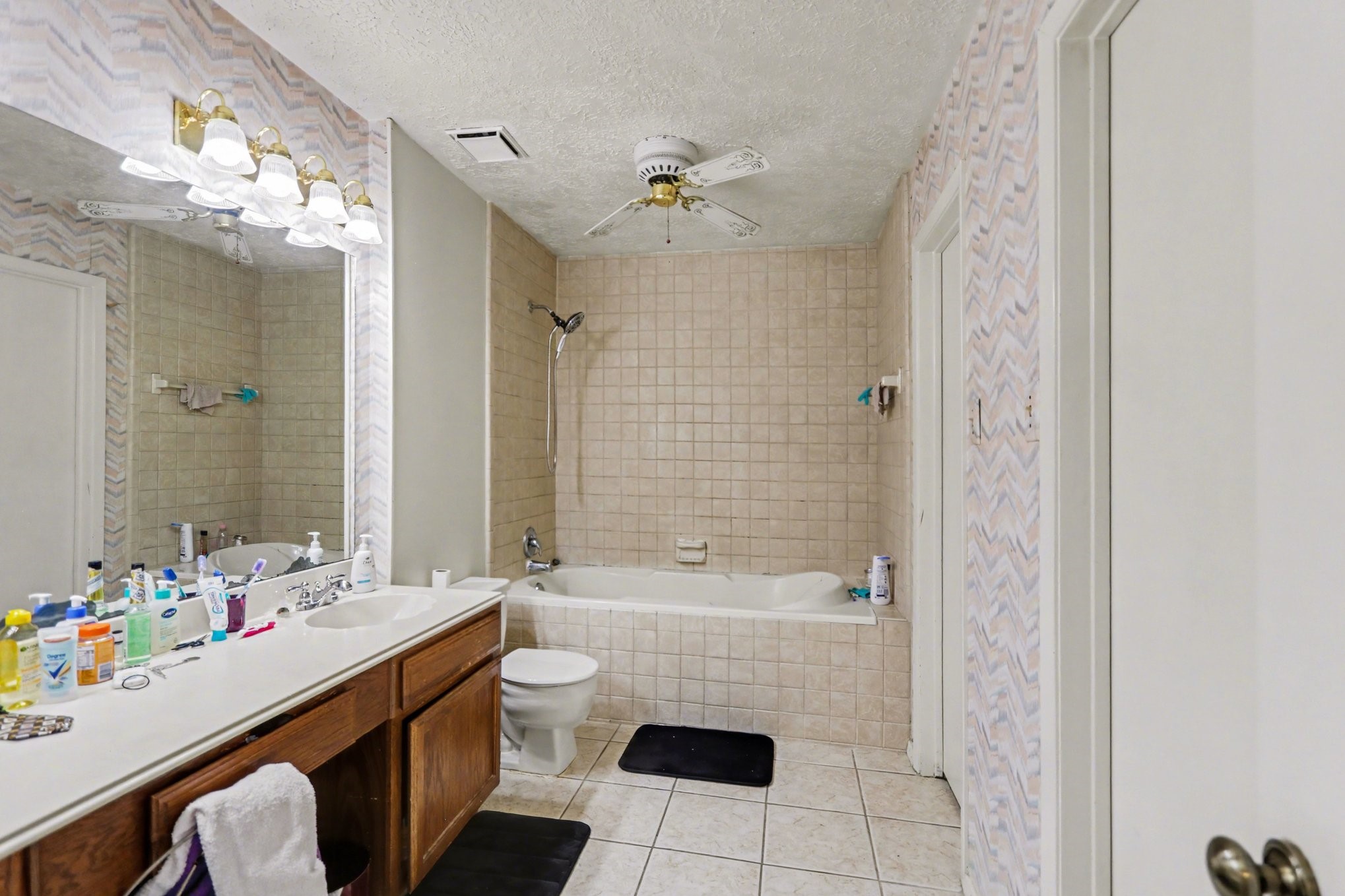 12151 Swords Creek Road Houston, TX 77067 - Photo 14 of 20 a bathroom with a sink a toilet a mirror and shower