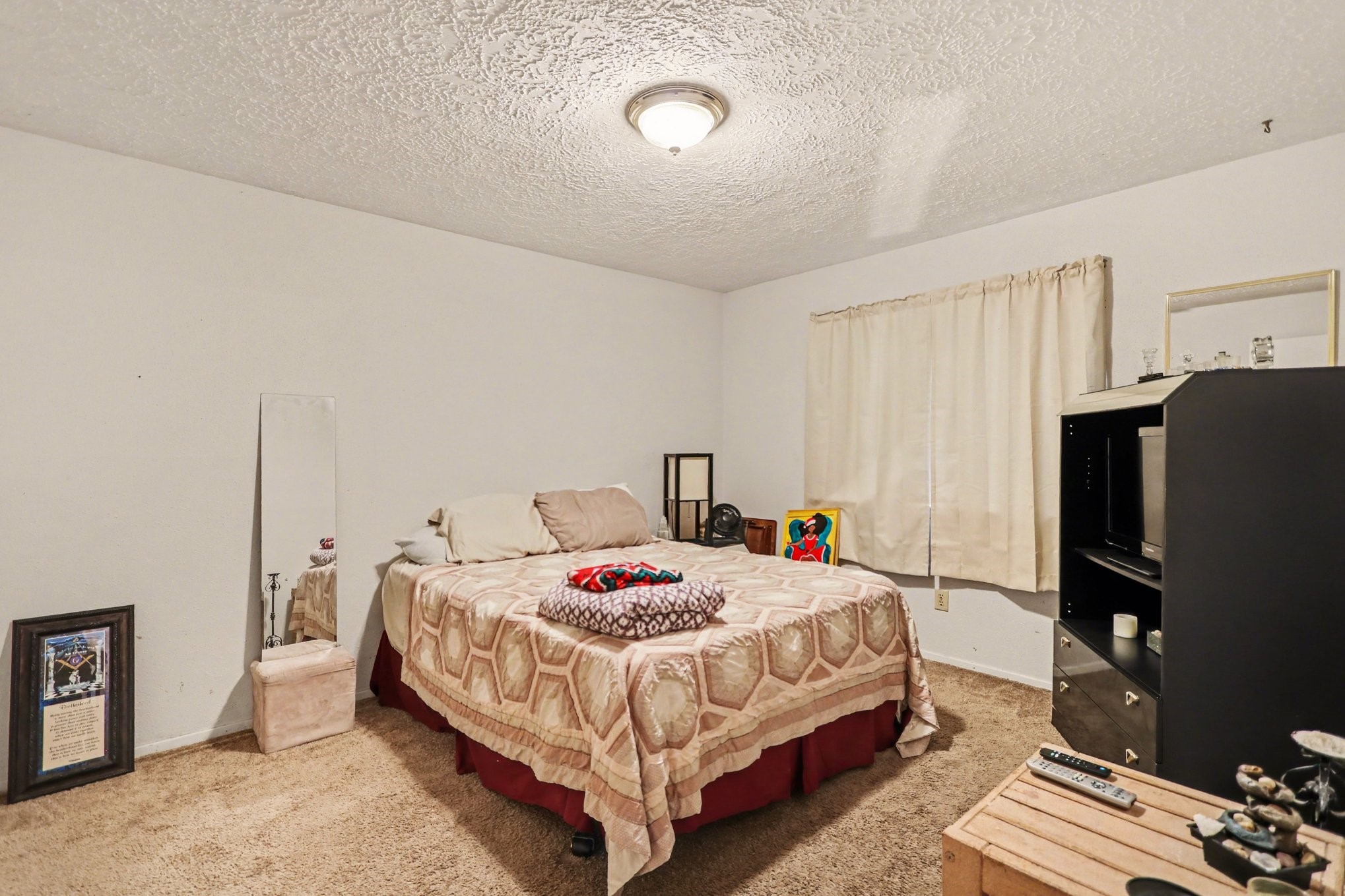 12151 Swords Creek Road Houston, TX 77067 - Photo 15 of 20 a bedroom with a bed and a flat screen tv