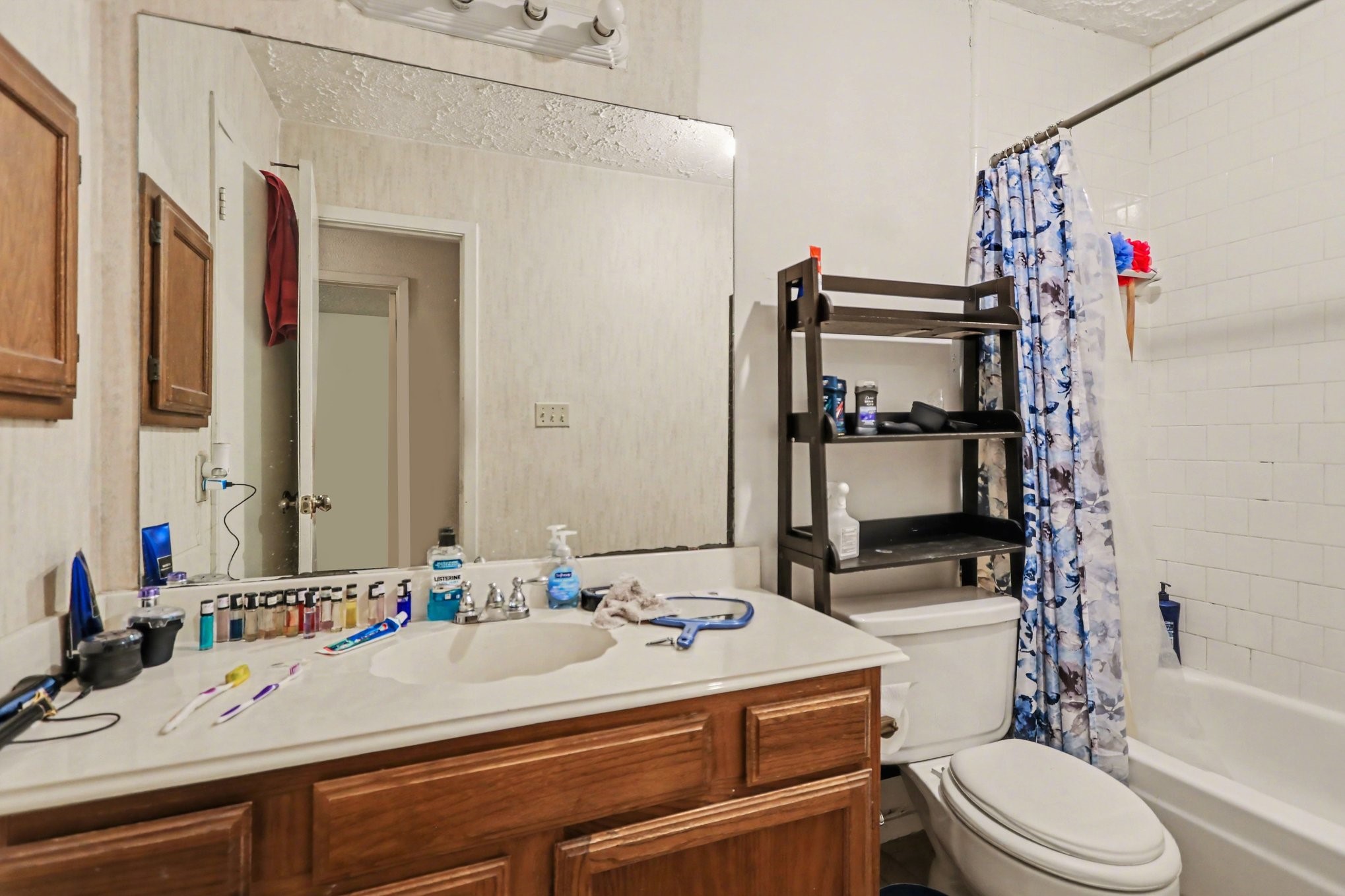 12151 Swords Creek Road Houston, TX 77067 - Photo 17 of 20 a bathroom with a sink a toilet and shower curtain