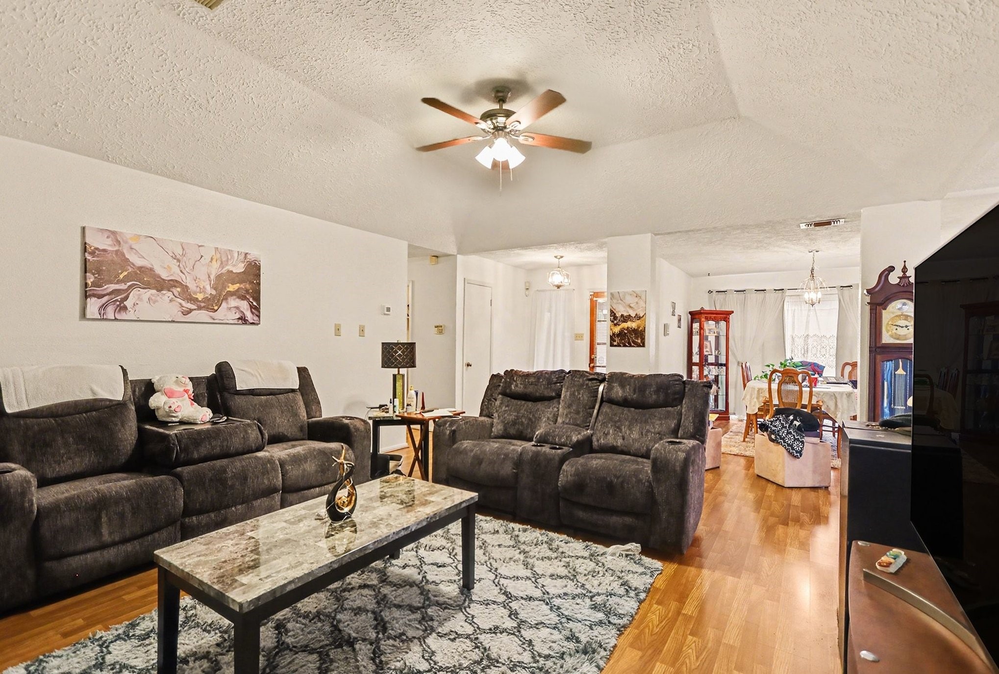 12151 Swords Creek Road Houston, TX 77067 - Photo 4 of 20 a living room with furniture and a flat screen tv