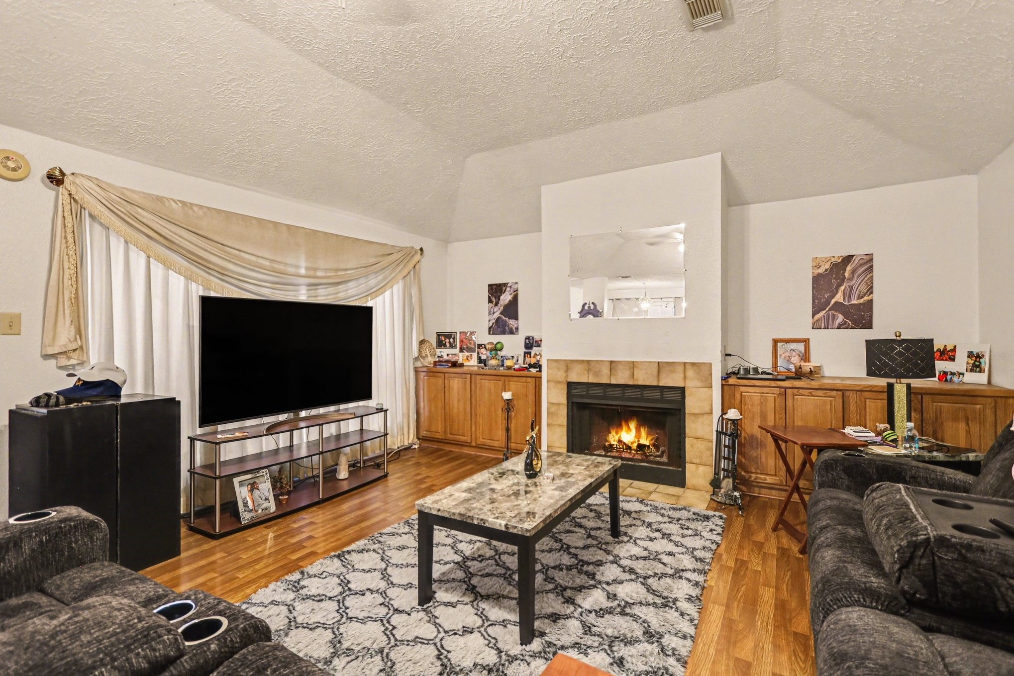 12151 Swords Creek Road Houston, TX 77067 - Photo 5 of 20 a living room with furniture fireplace and flat screen tv
