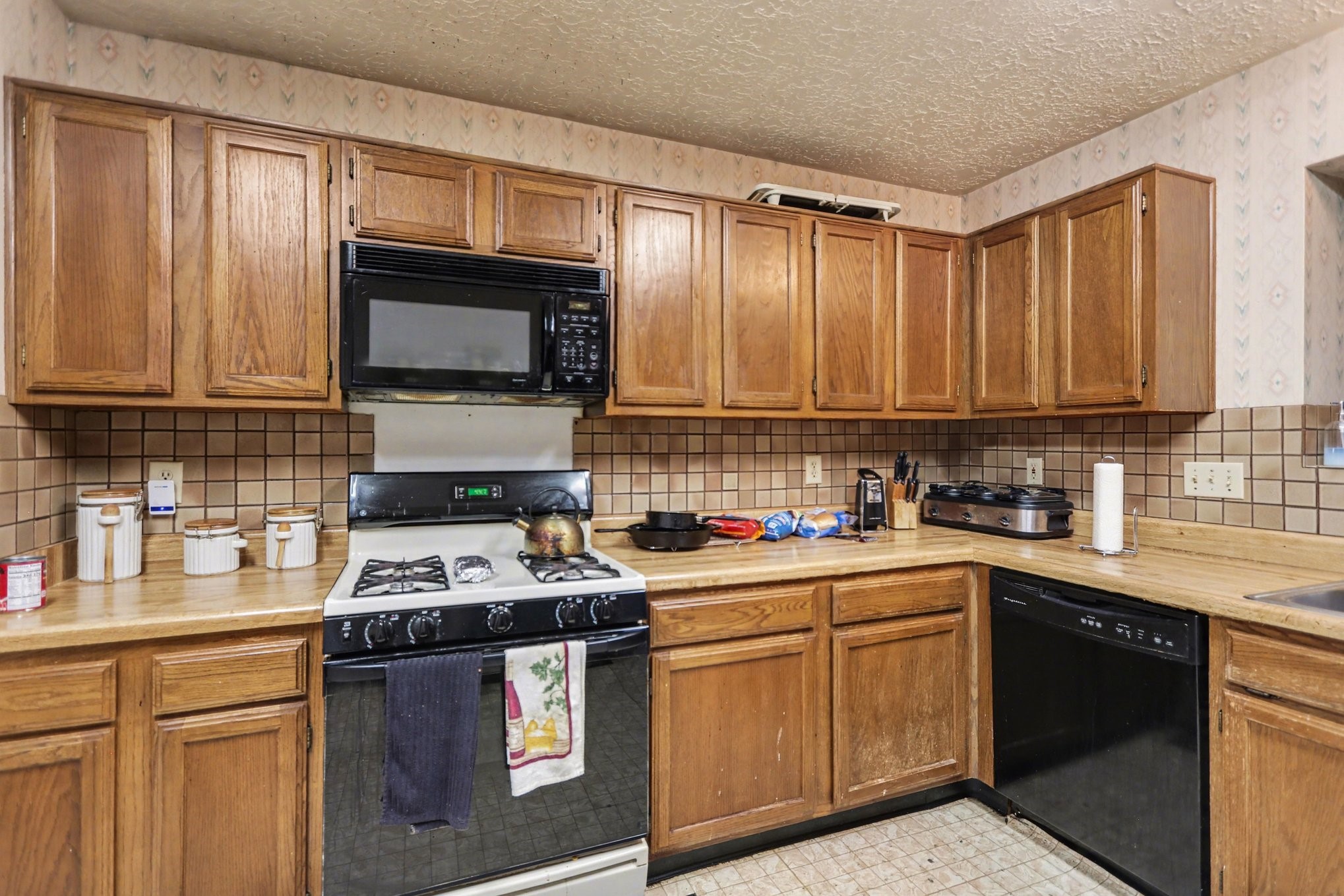 12151 Swords Creek Road Houston, TX 77067 - Photo 8 of 20 a kitchen with stainless steel appliances granite countertop a stove sink microwave and cabinets