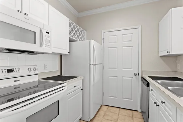 a kitchen with cabinets and a stove top oven