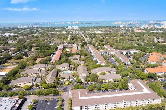 an aerial view of residential building with green space