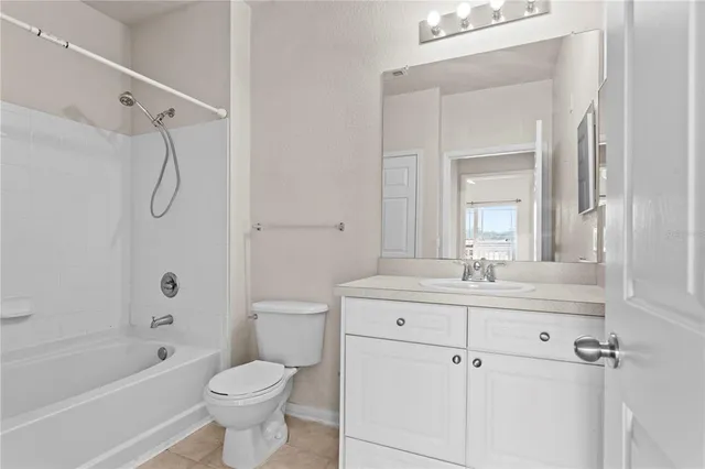 a bathroom with a double vanity sink toilet mirror and bathtub