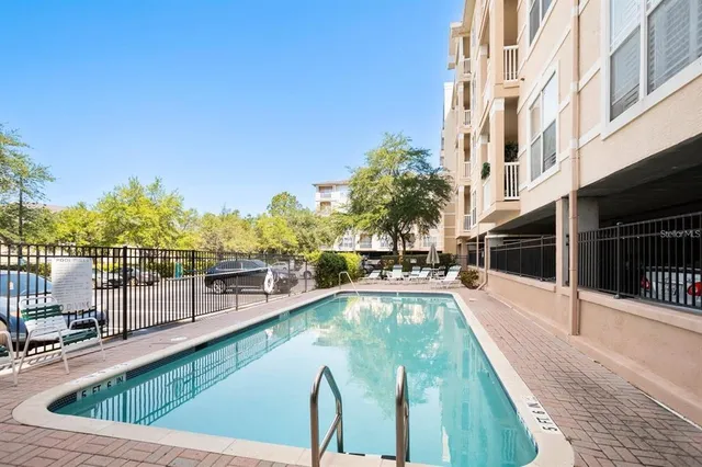 a view of a swimming pool with a lounge chair