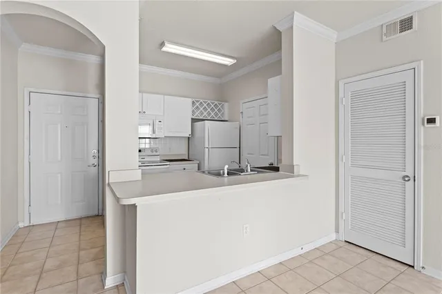 a kitchen with stainless steel appliances a refrigerator and a stove