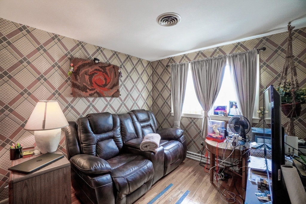 53 Yale Road Needham, MA 02494 - Photo 10 of 21 a living room with furniture and a flat screen tv