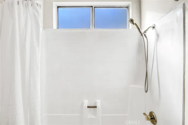 a bathroom with a bathtub and shower
