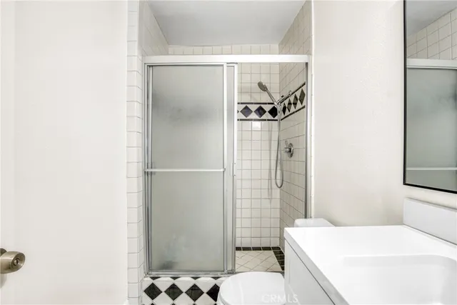 a bathroom with a sink toilet and shower