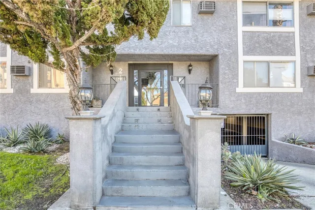 a front view of a house with potted plants