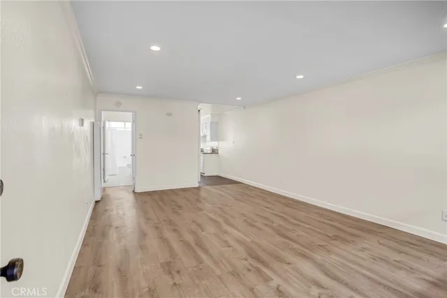 an empty room with wooden floor