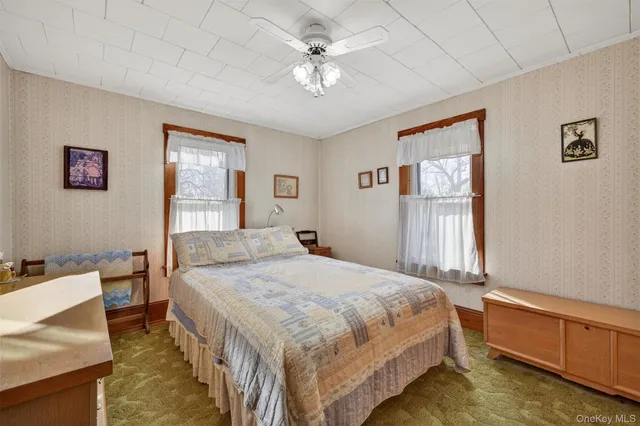 a bedroom with a bed dresser and a window