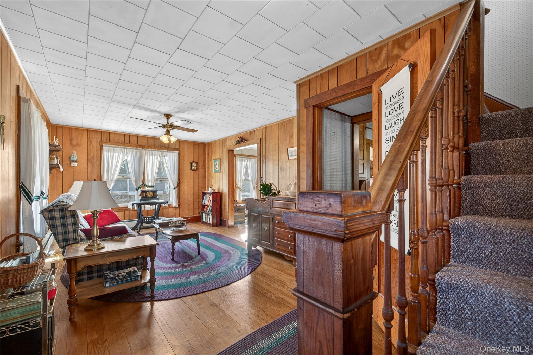 21 Innis Avenue Newburgh, NY 12550 - Photo 5 of 22 a living room with furniture a flat screen tv and a refrigerator