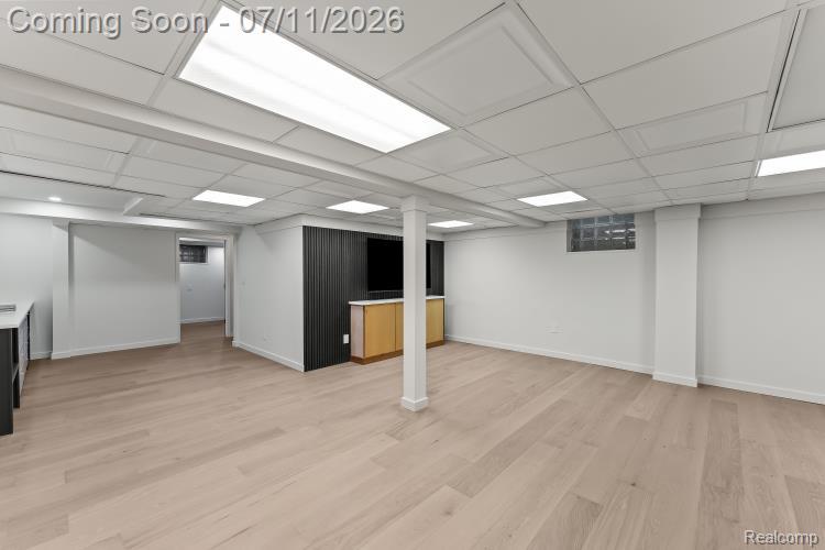 4154 Nearbrook Road Bloomfield Hills, MI 48302 - Photo 40 of 47 Spacious finished lower level featuring light wood-finish flooring, white walls, and a dropped ceiling with integrated lighting