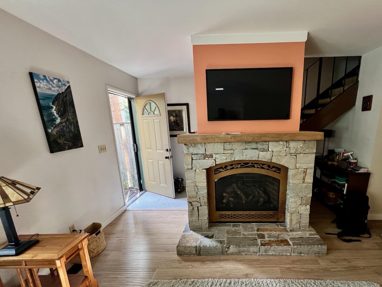 3101 Lake Forest Road, Unit 149 Tahoe City, CA 96145 - Photo 3 of 18 a living room with a fireplace and a flat screen tv