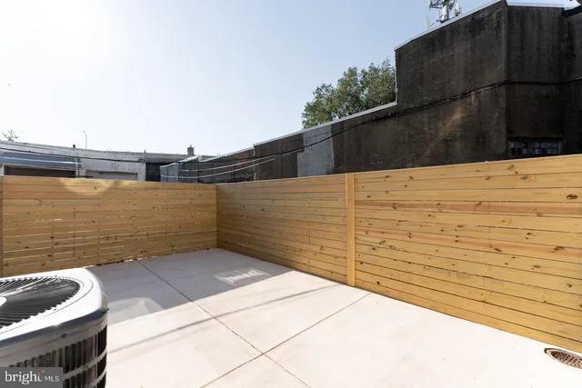 a view of a wooden door and a wooden fence