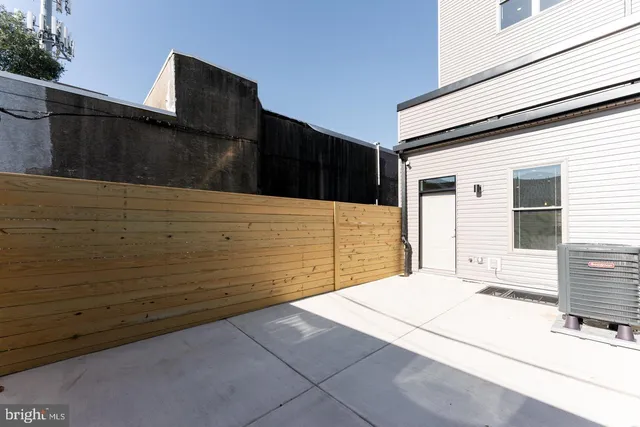a view of an empty room with wooden floor and closet