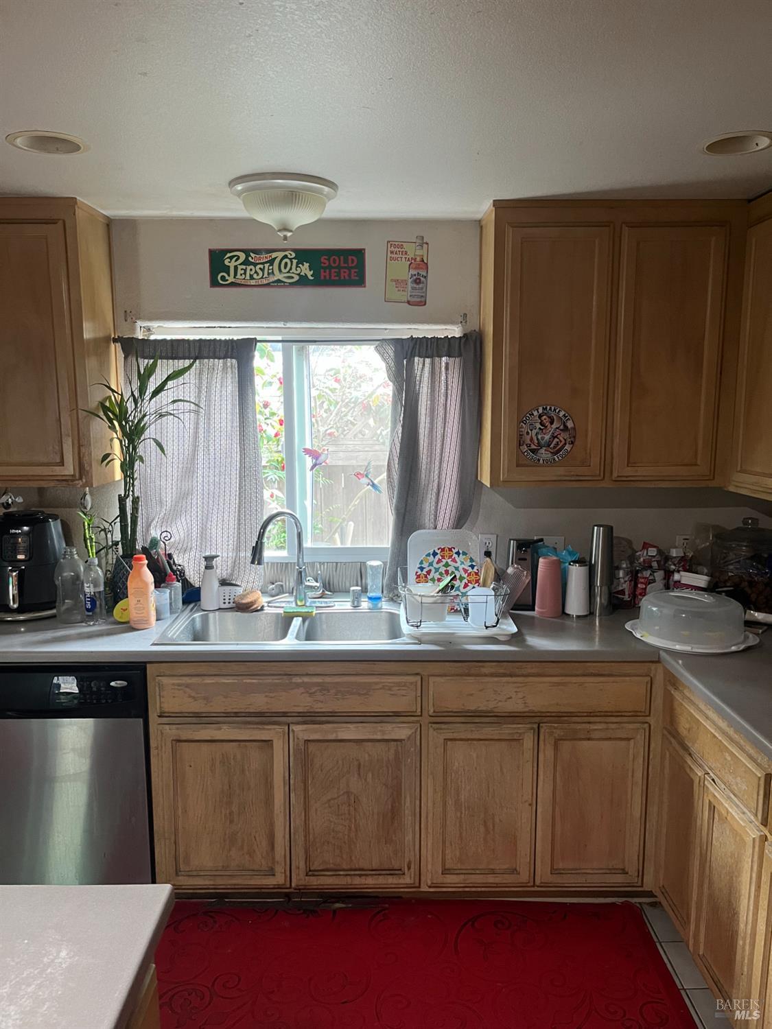 1889 Jennings Avenue Santa Rosa, CA 95401 - Photo 4 of 10 a kitchen with stainless steel appliances a sink dishwasher stove and cabinets