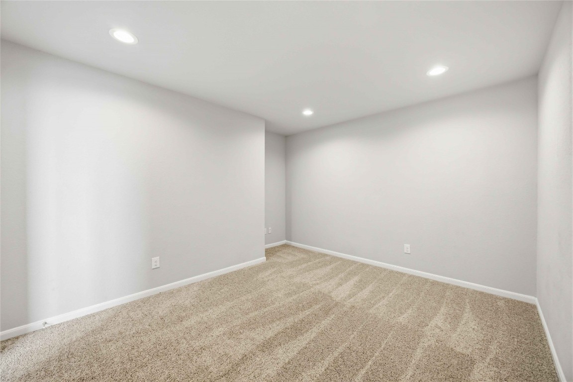 703 Autumn Flats Way Rosharon, TX 77583 - Photo 12 of 18 Step into your own private cinema with this dedicated media room, a specialized space designed for the ultimate entertainment experience. Tucked away from the main living areas, this room offers a quiet, windowless environment—ideal for controlling lighting and optimizing acoustics for movie marathons or intense gaming sessions