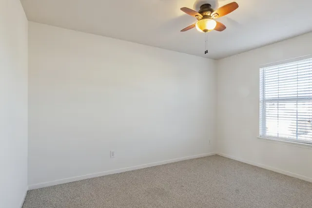 a bathroom with a sink a toilet and shower curtain