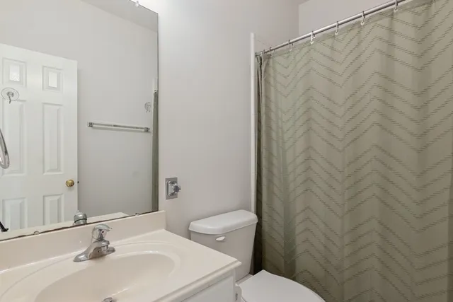 an empty room with a window and a ceiling fan