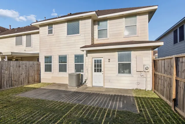 a view of a backyard with wooden fence