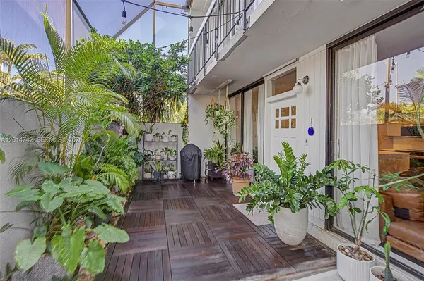 a view of a balcony with chair and potted plants