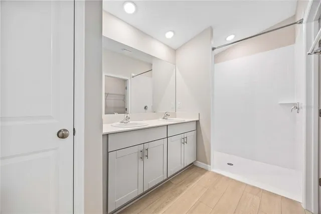 a bathroom with a double vanity sink and mirror