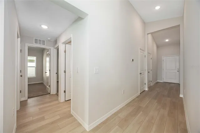 a view of a hallway with wooden floor