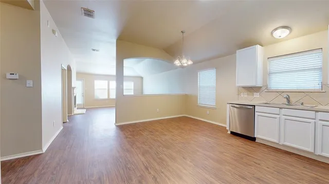 a view of a kitchen with a sink and a stove top oven