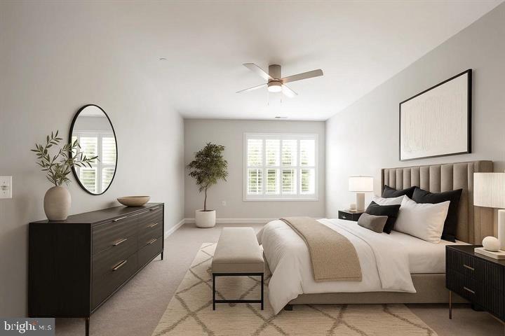 10530 Resort Road, Unit 210 Ellicott City, MD 21042 - Photo 11 of 35 a bedroom with a bed a mirror and a window