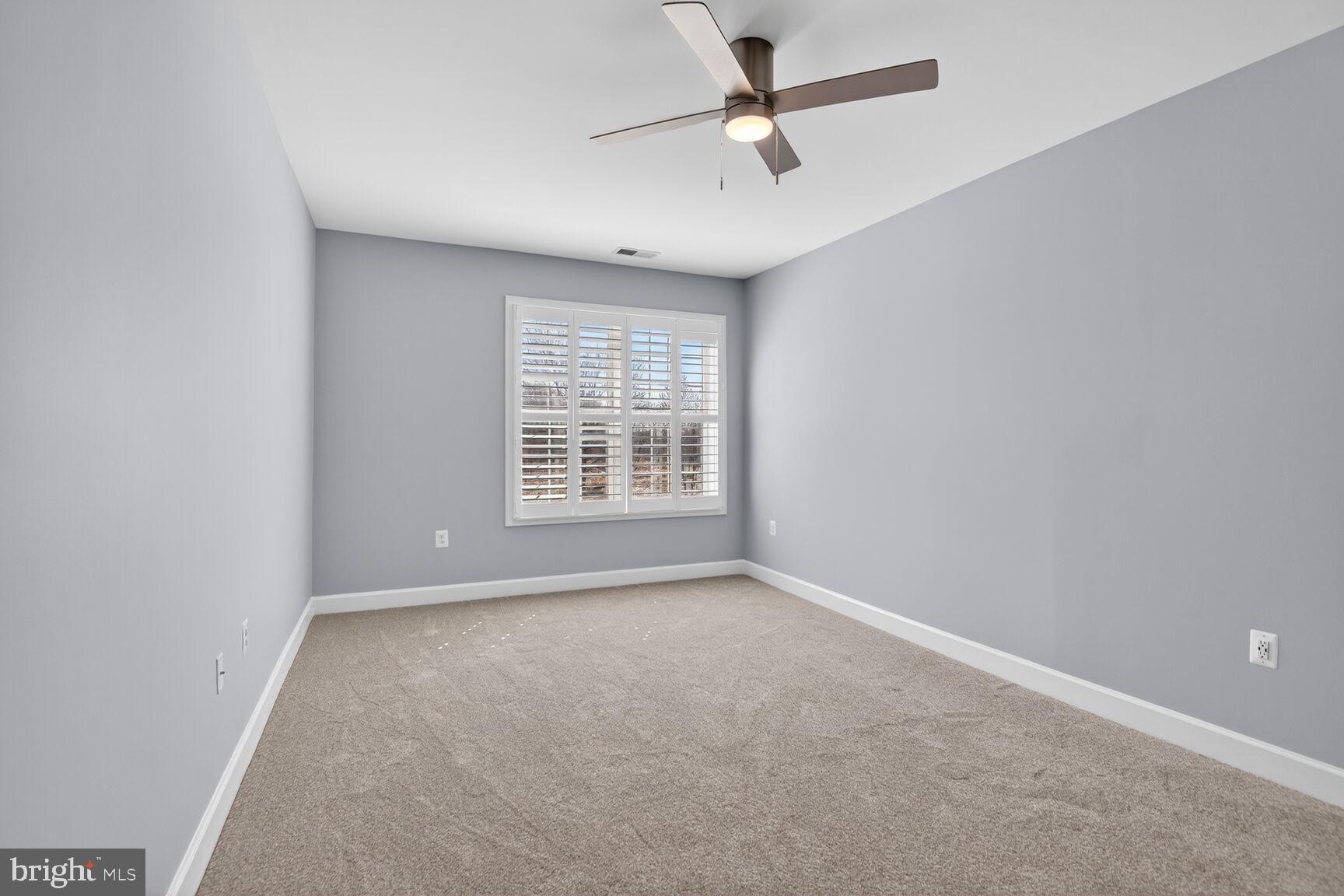 10530 Resort Road, Unit 210 Ellicott City, MD 21042 - Photo 12 of 35 an empty room with windows and fan